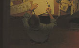 An overheard shot of Cleveland Heep (Paul Giamatti) sitting at his desk.