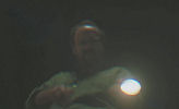 Cleveland Heep (Paul Giamatti) looking through the water with a flashlight.
