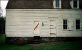 The red marking on a house in "The village"